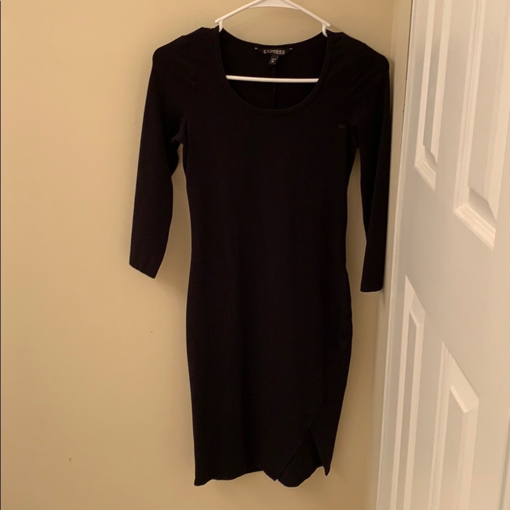 Black midway length dress with small slit.